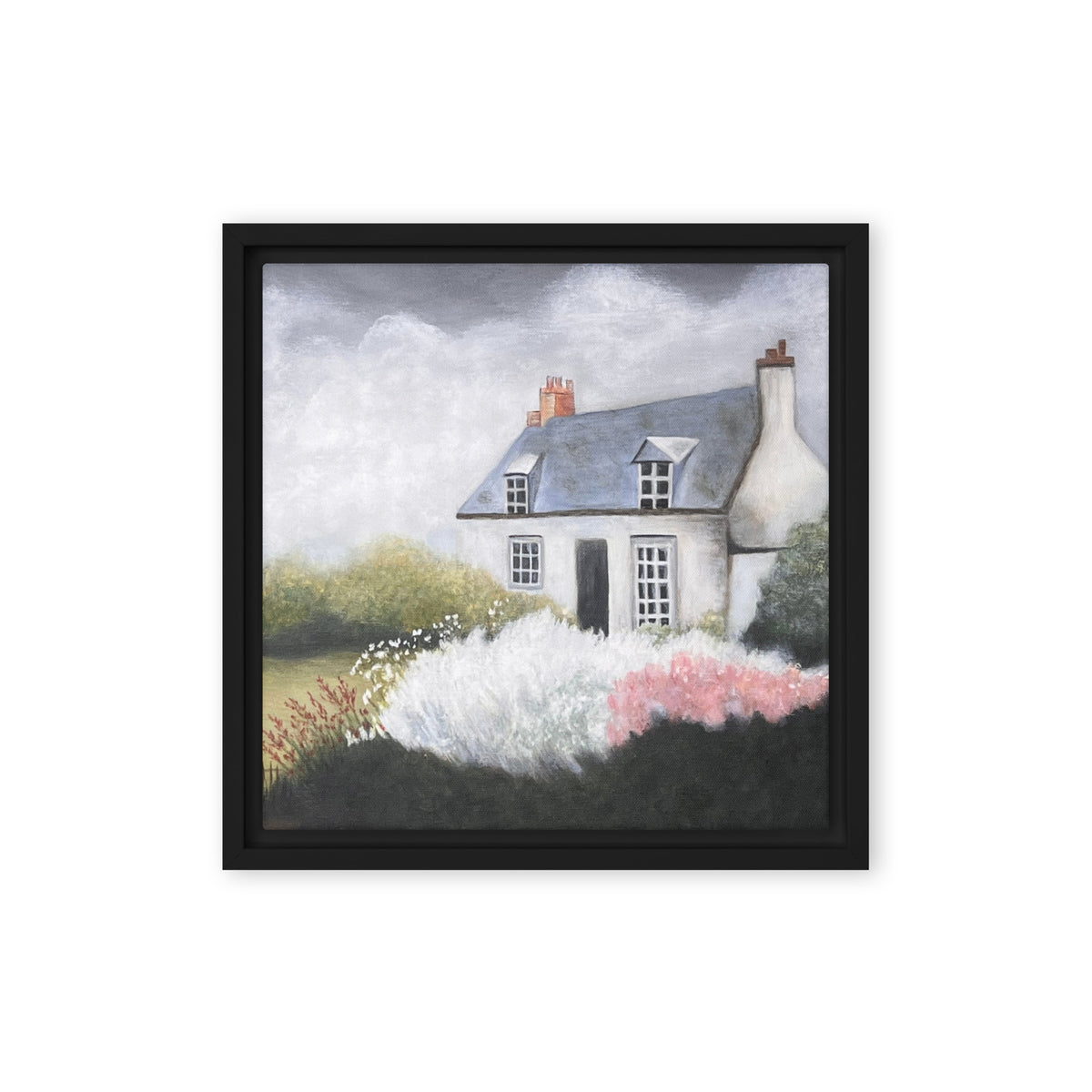 Framed artwork of a quaint house with flowers in front on a white background