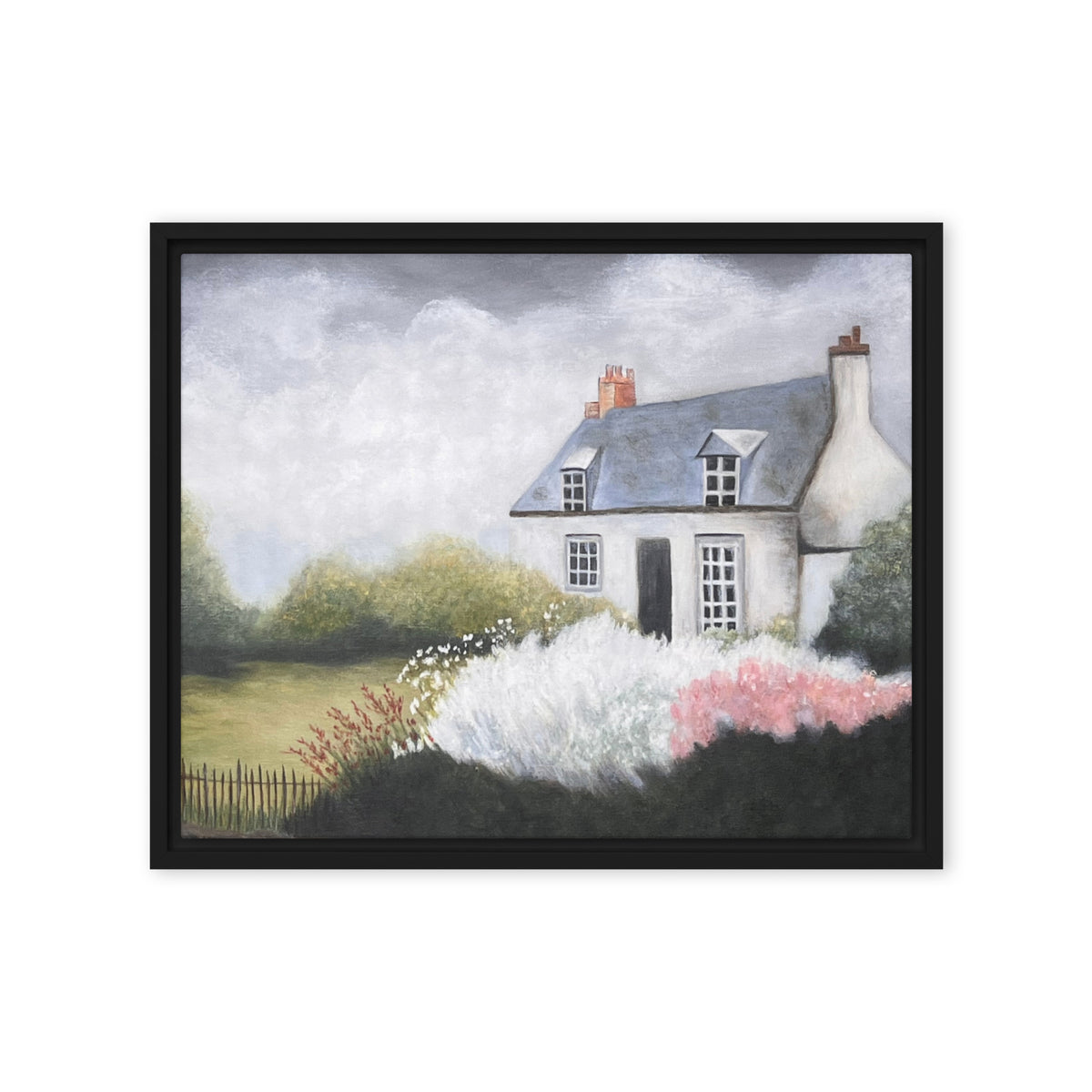 Framed artwork of a quaint house with a garden on a white background